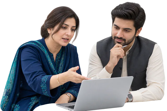 Two school leaders reviewing information on a laptop.